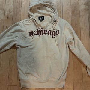 Beige UChicago hoodie with eagle patch in the arm size small